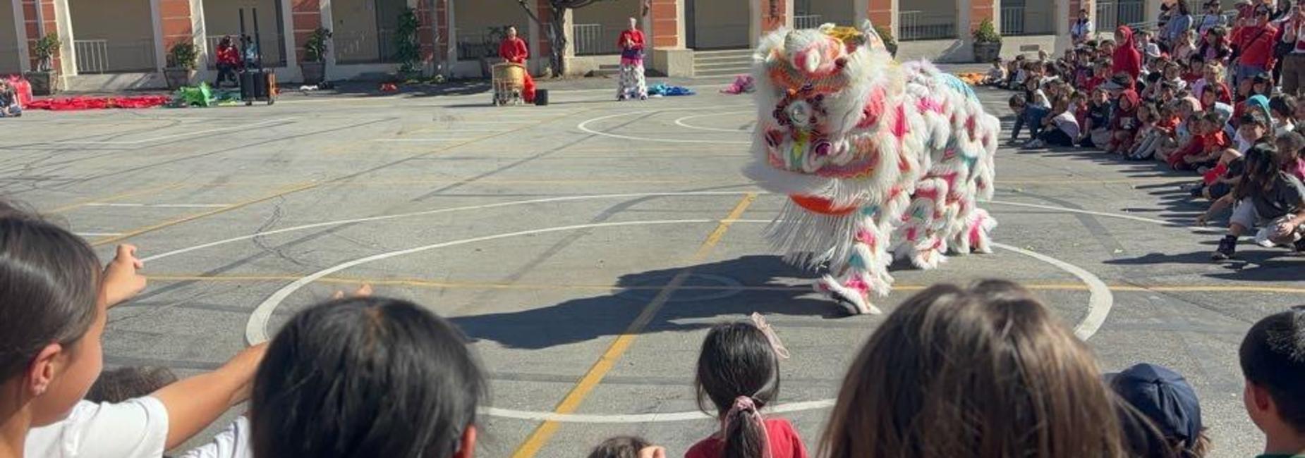 Students enjoying a Lion Dance for Lunar New Year