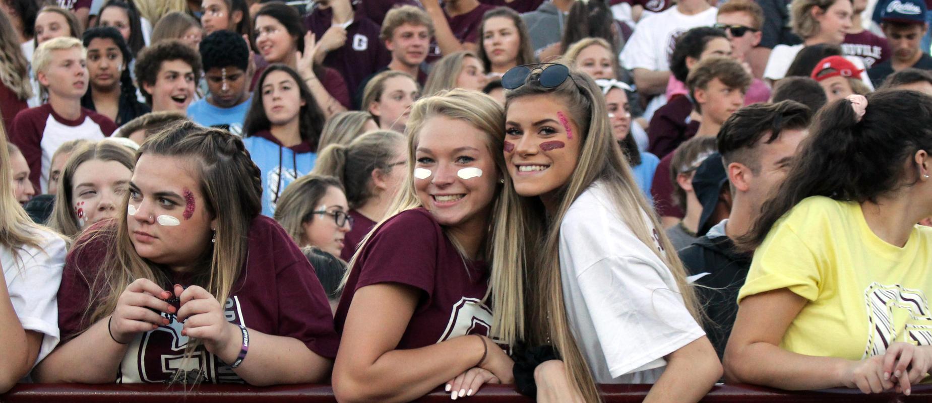 crowd wears school colors at homecoming football game