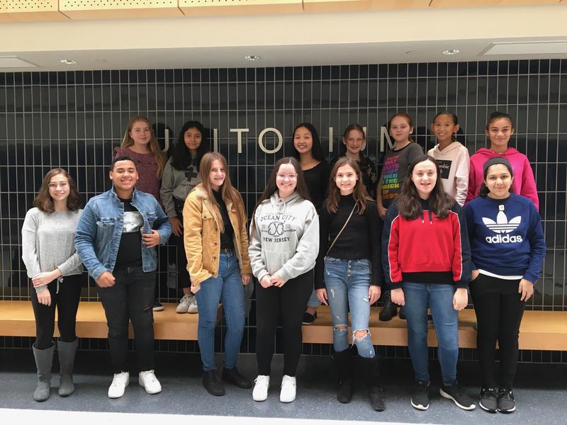 14 middle school students pose for a photo outside the auditorium, prior to performing in Bucks County Music Educators String Day.