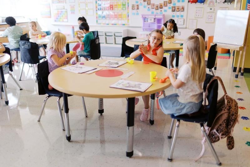 Kindergarten students play with play doh at orientation