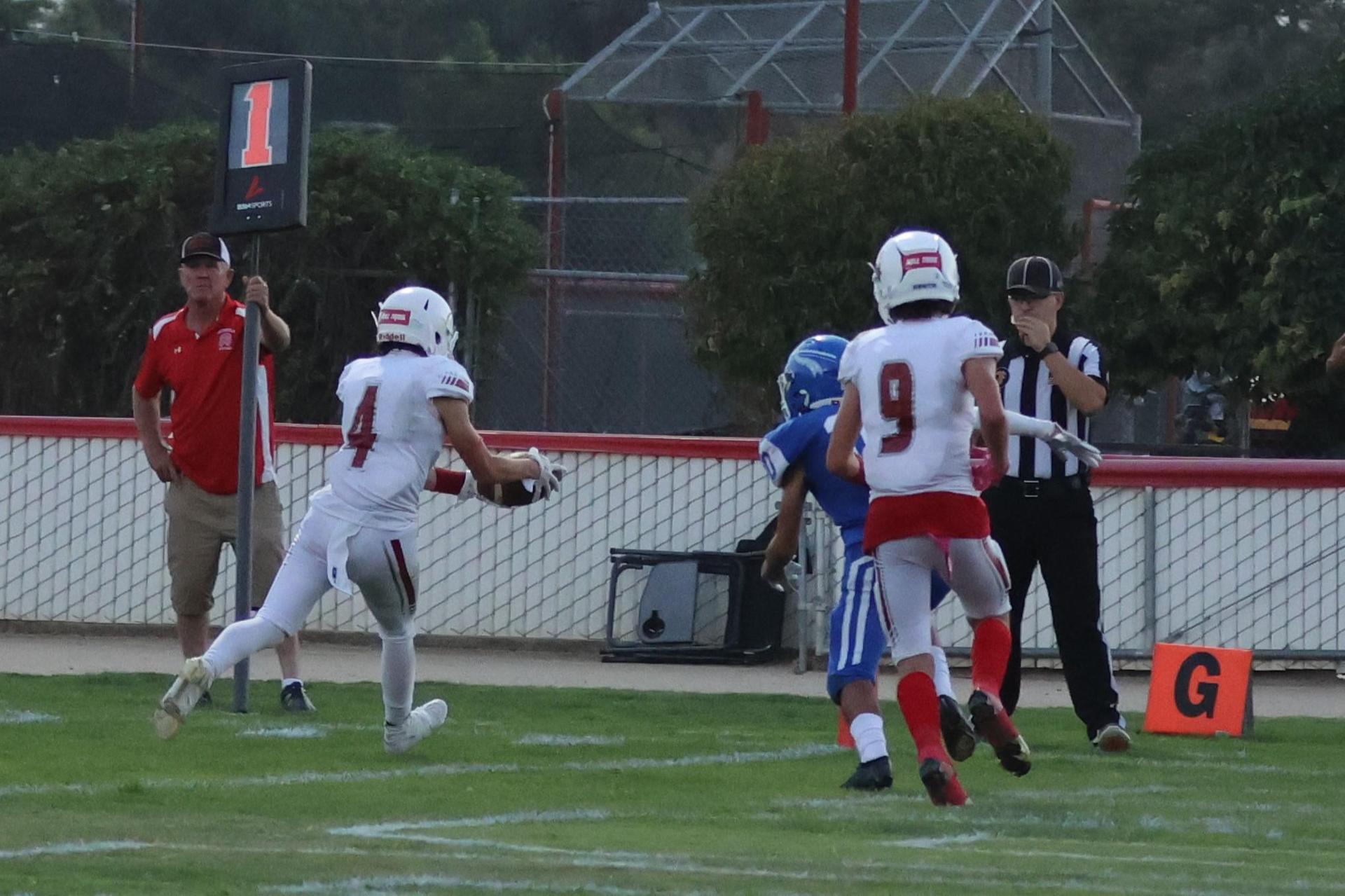 Junior Varsity football players in action against Caruthers