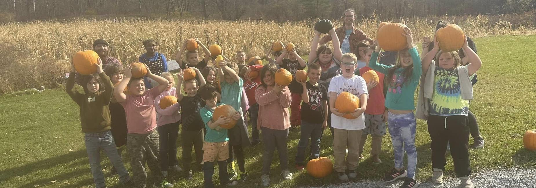 students with pumpkins