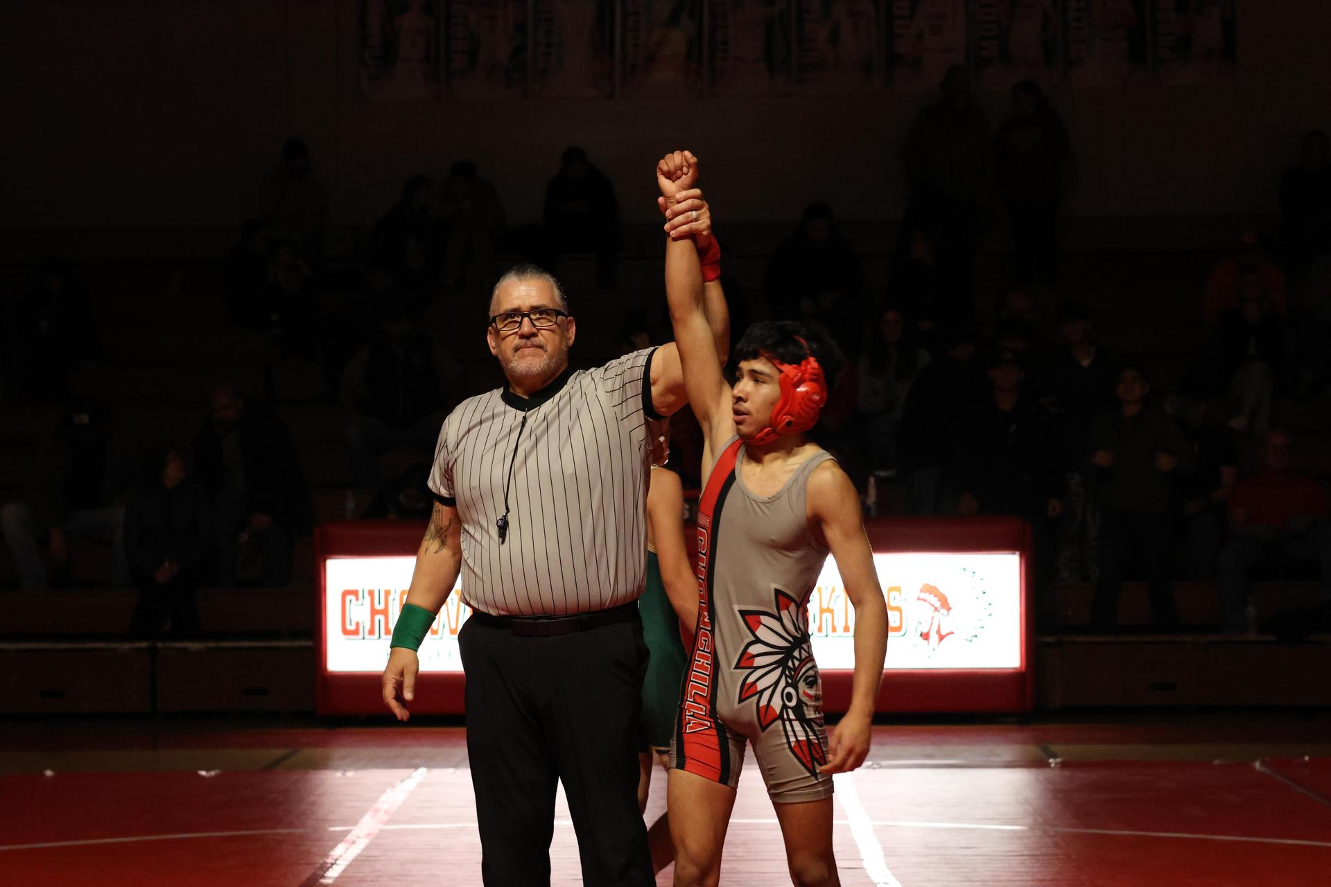 Wrestling winners with hands up 138