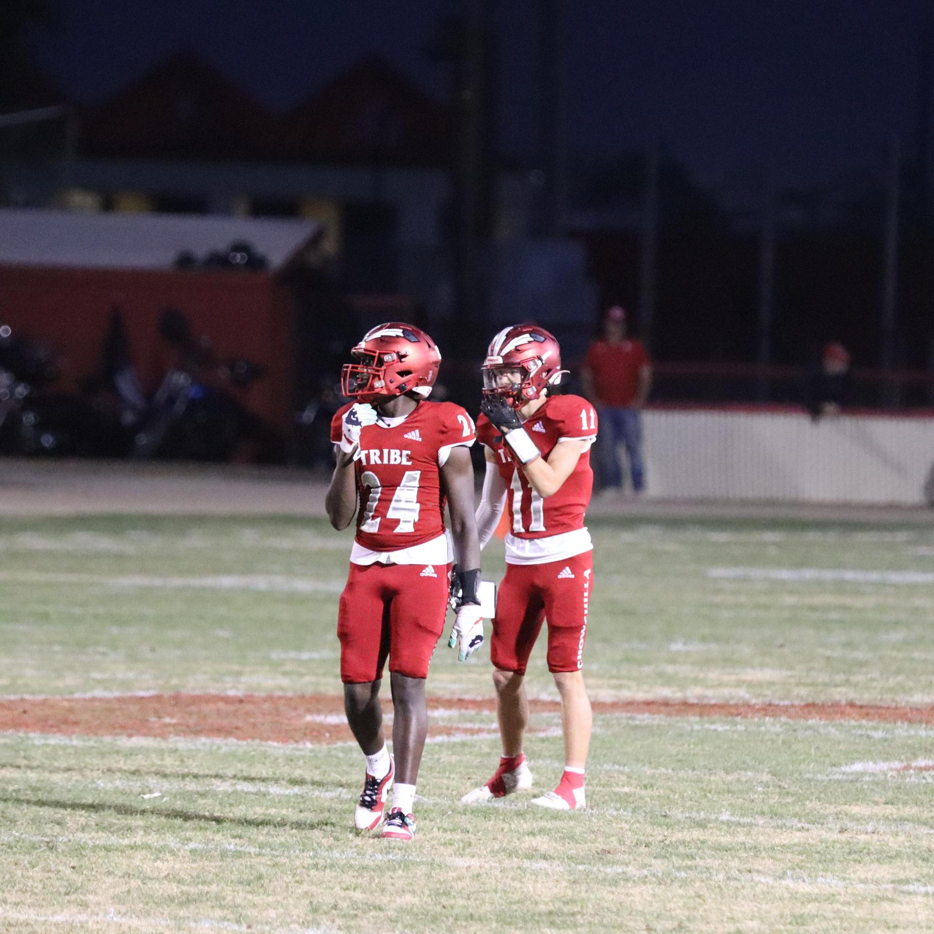 varsity football players in action against Riverdale
