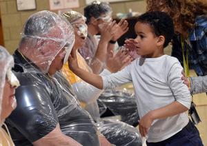 a student tossing a pie into a teacher's face