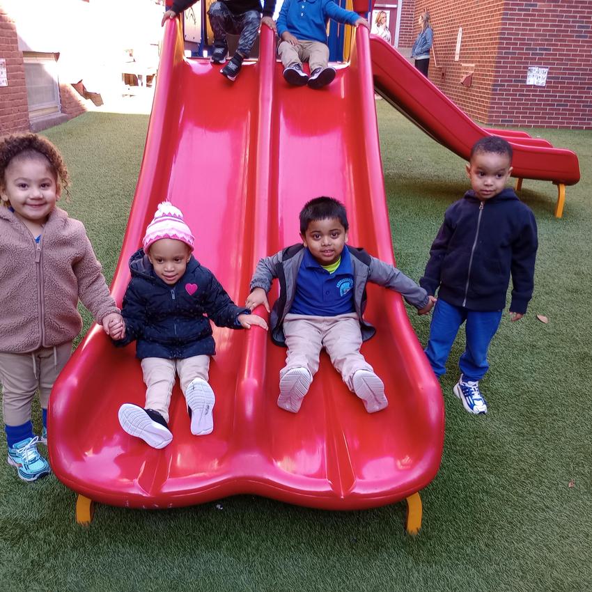 Children sitting on a slide