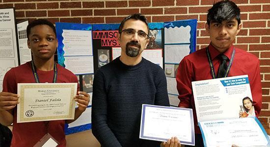 Students showing their science fair certificates