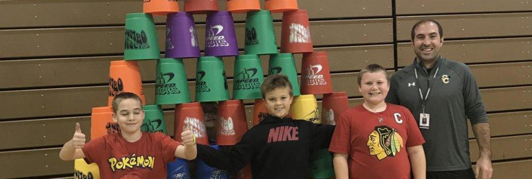 Three boys stacking bucklets