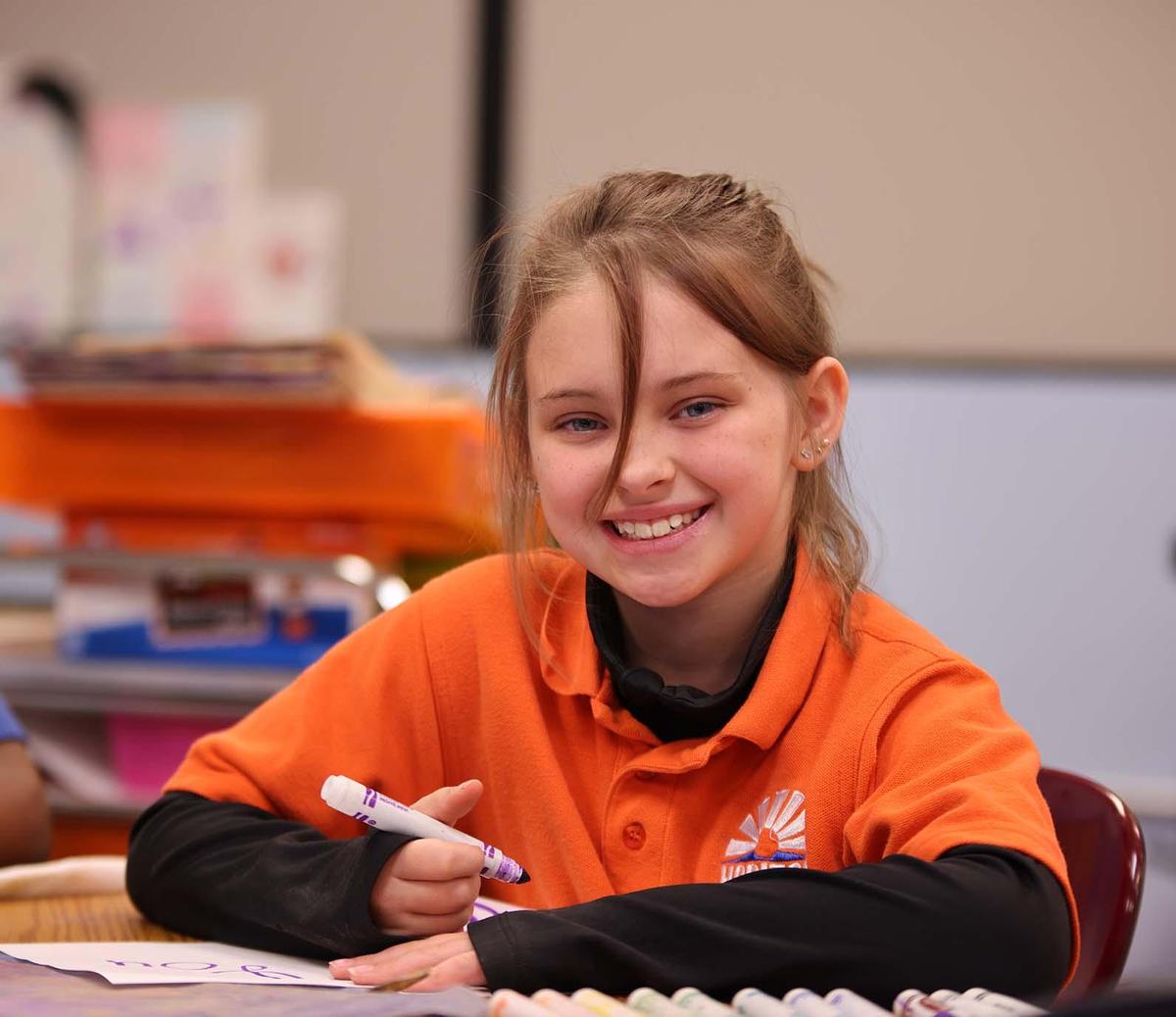 Horizon Science Academy of Lorain student wearing headphones uses a laptop in class