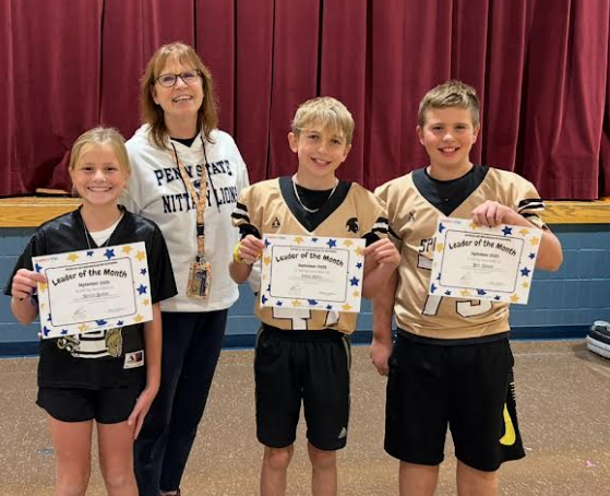 pic of students and a principal with kids holding certificates