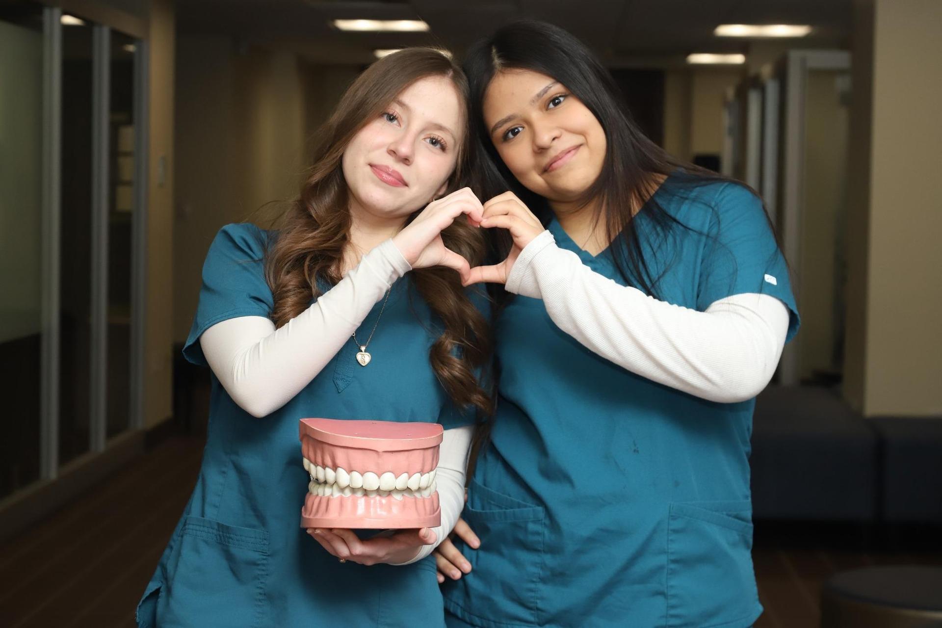 dental students making heart hands
