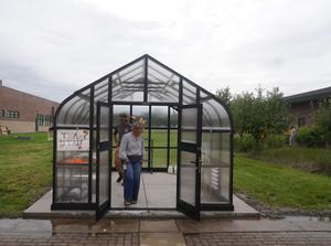 Guests go inside the greenhouse to check it out.