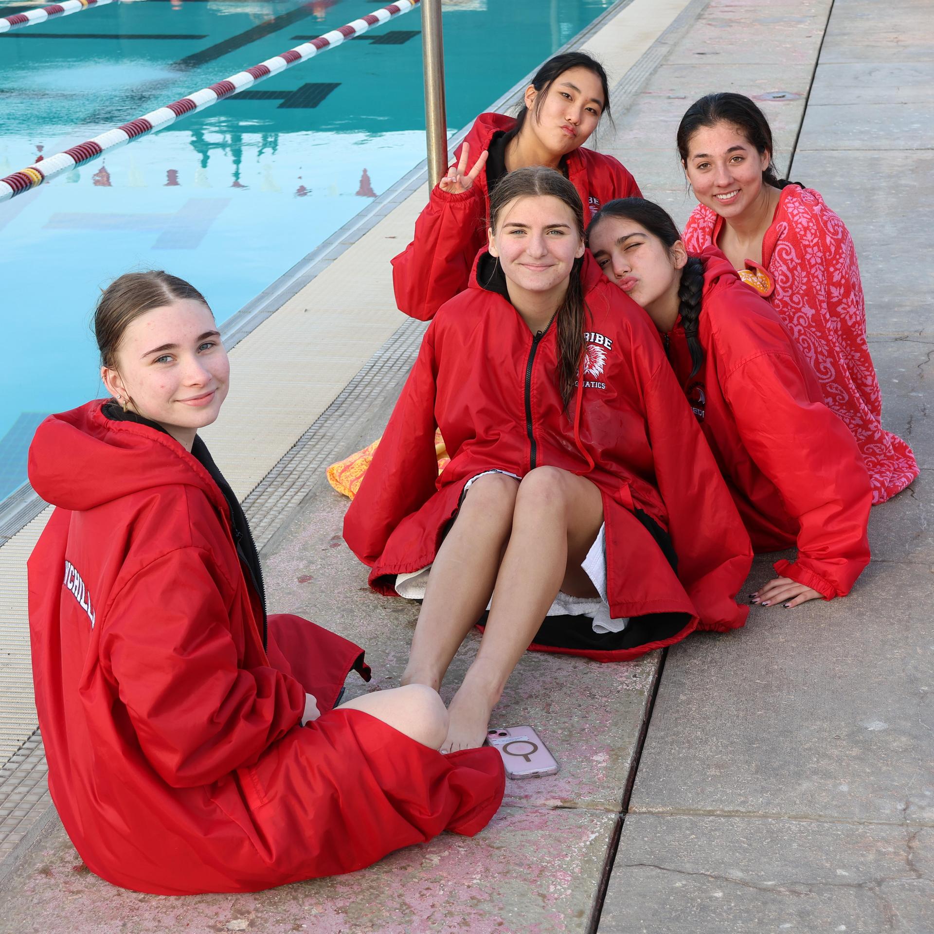swimmers sitting posing for the camera
