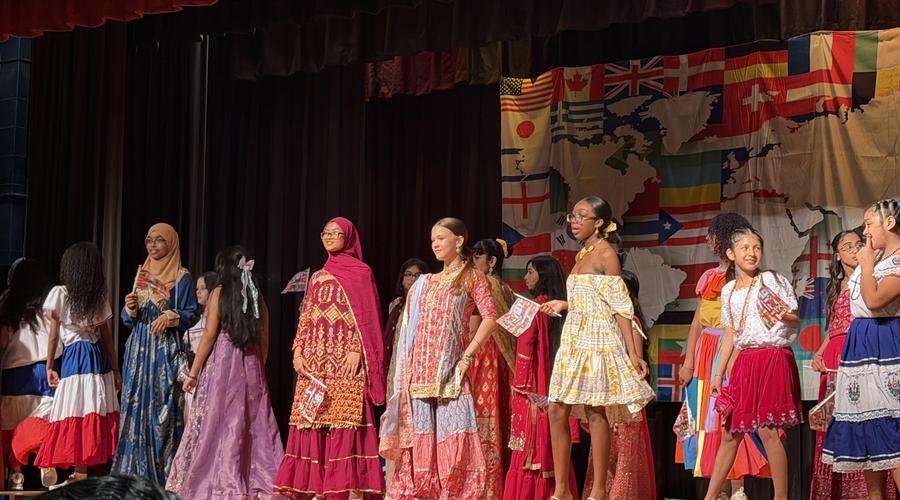 Girls on a stage with traditional dresses
