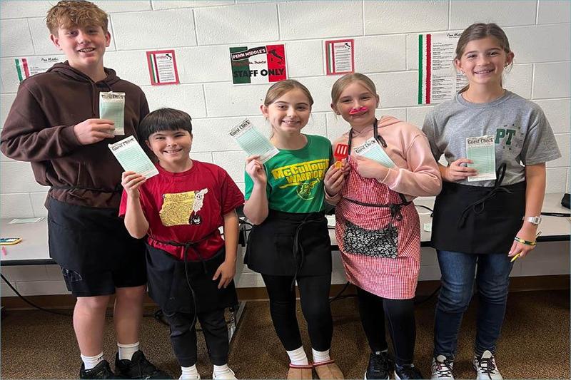 Jackson Prather, Aiden Milko, Shylie Immel, Coraline Ward, and Adalina Ament total up their customers’ checks, calculate the tip, and present the final cost per person to their tables