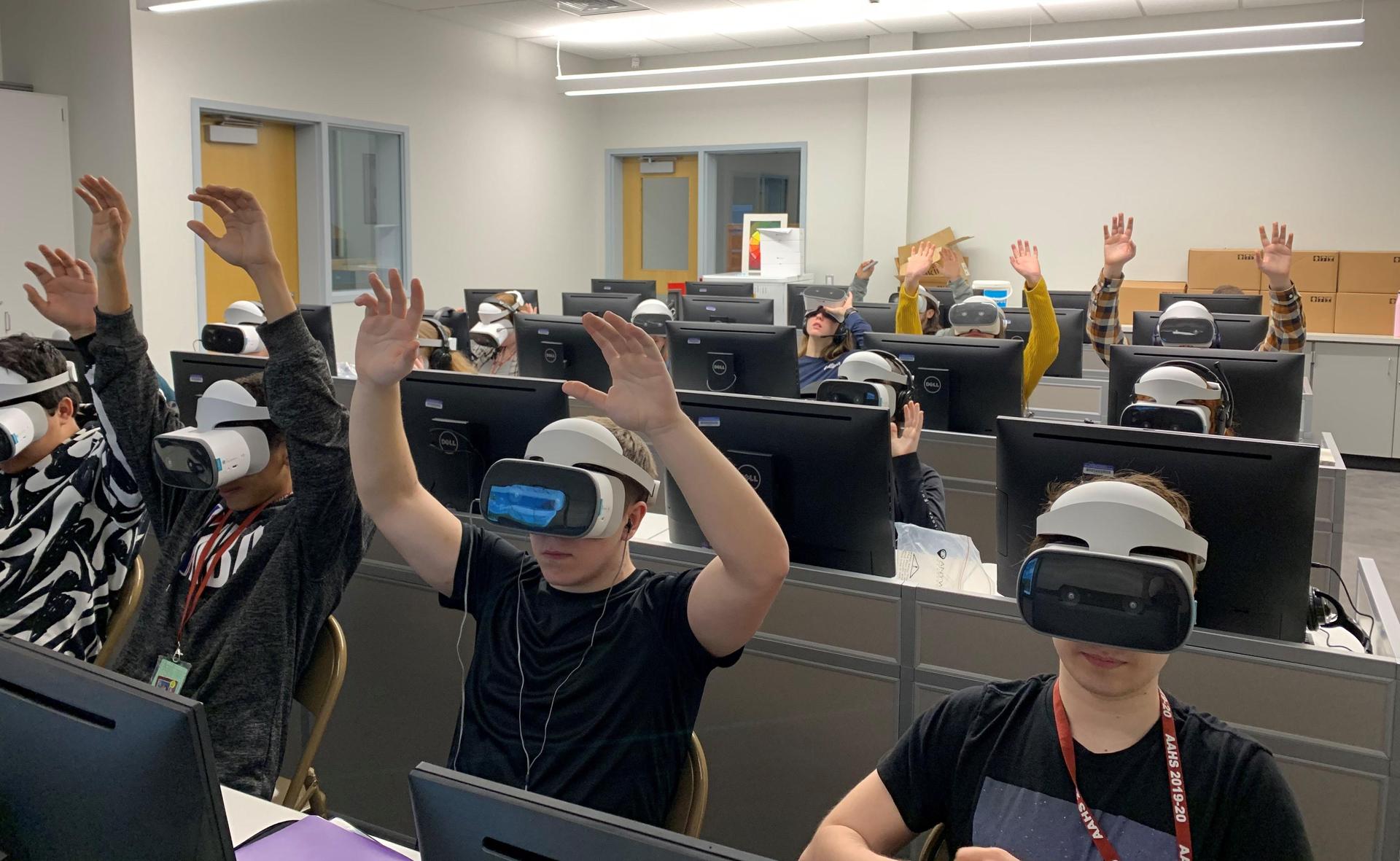 Students from Mr. Borst's physics class ride and analyze VR roller coasters with guest Saint Francis Professor, Dr. Joel Bandstra at the AAHS Library.