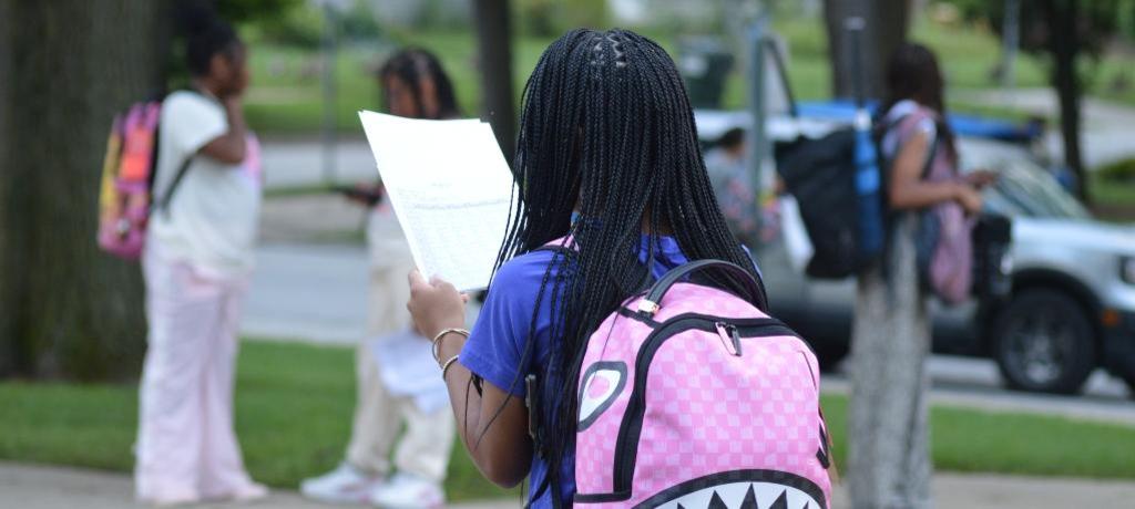 Girl reads assignments.