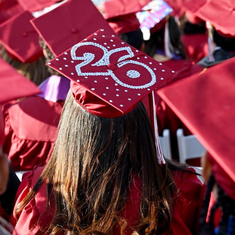 Back view of a graduate's cap decorated with pearls and the number 26.