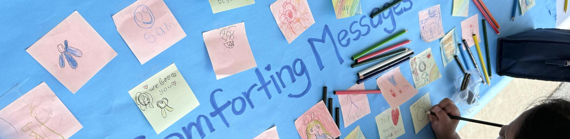 post it notes on a banner with comforting messages