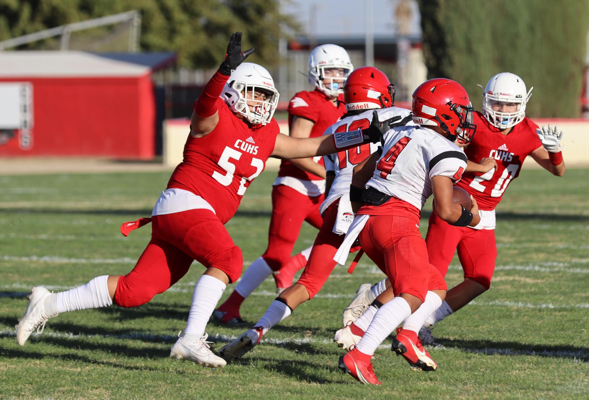 junior varsity football players in action against Fowler