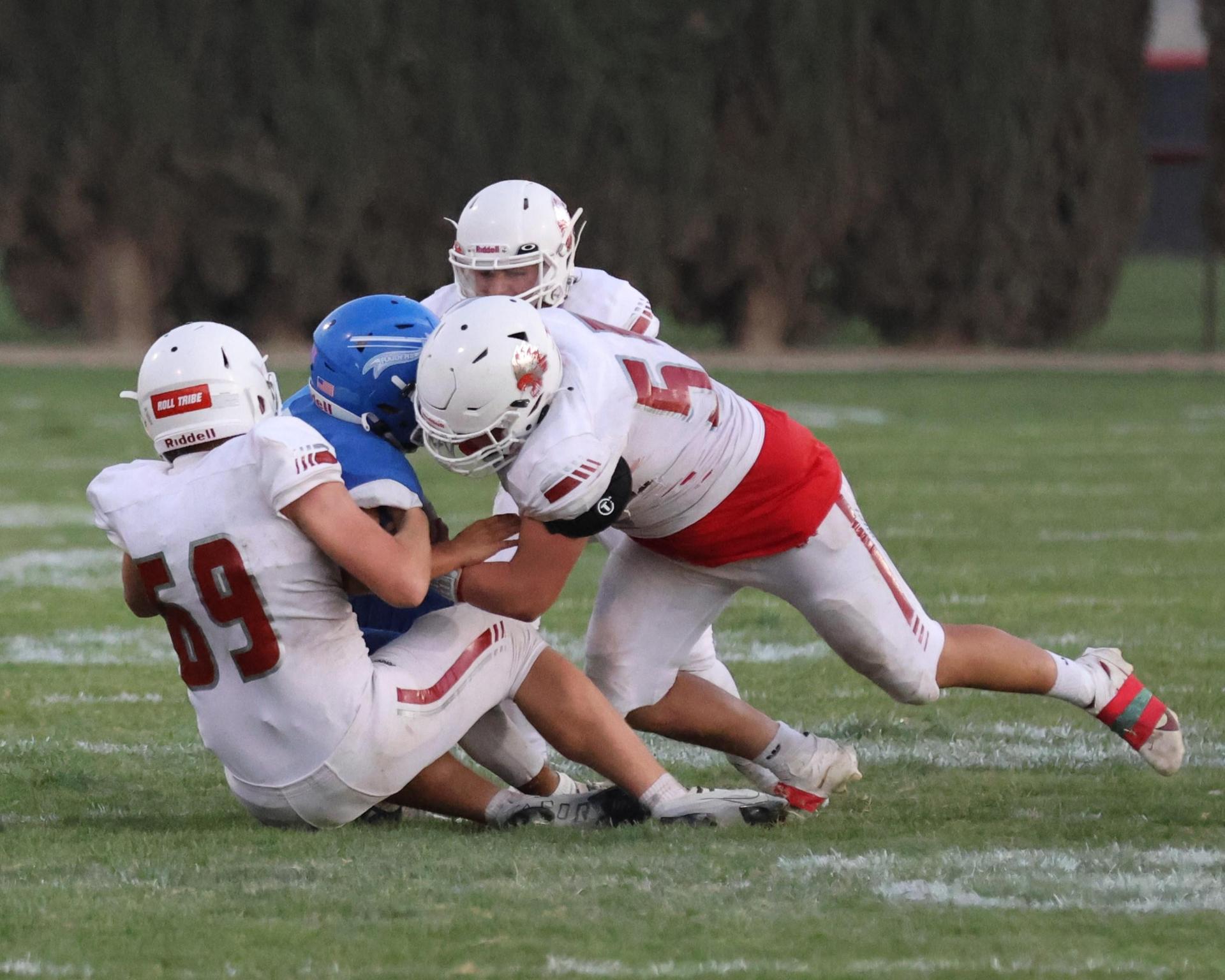Junior Varsity football players in action against Caruthers