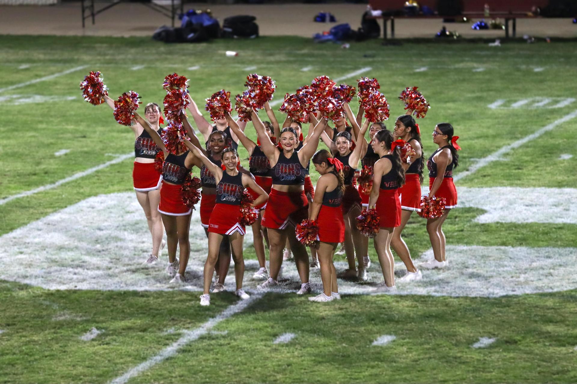 Varsity girls cheering at the Parlier football game