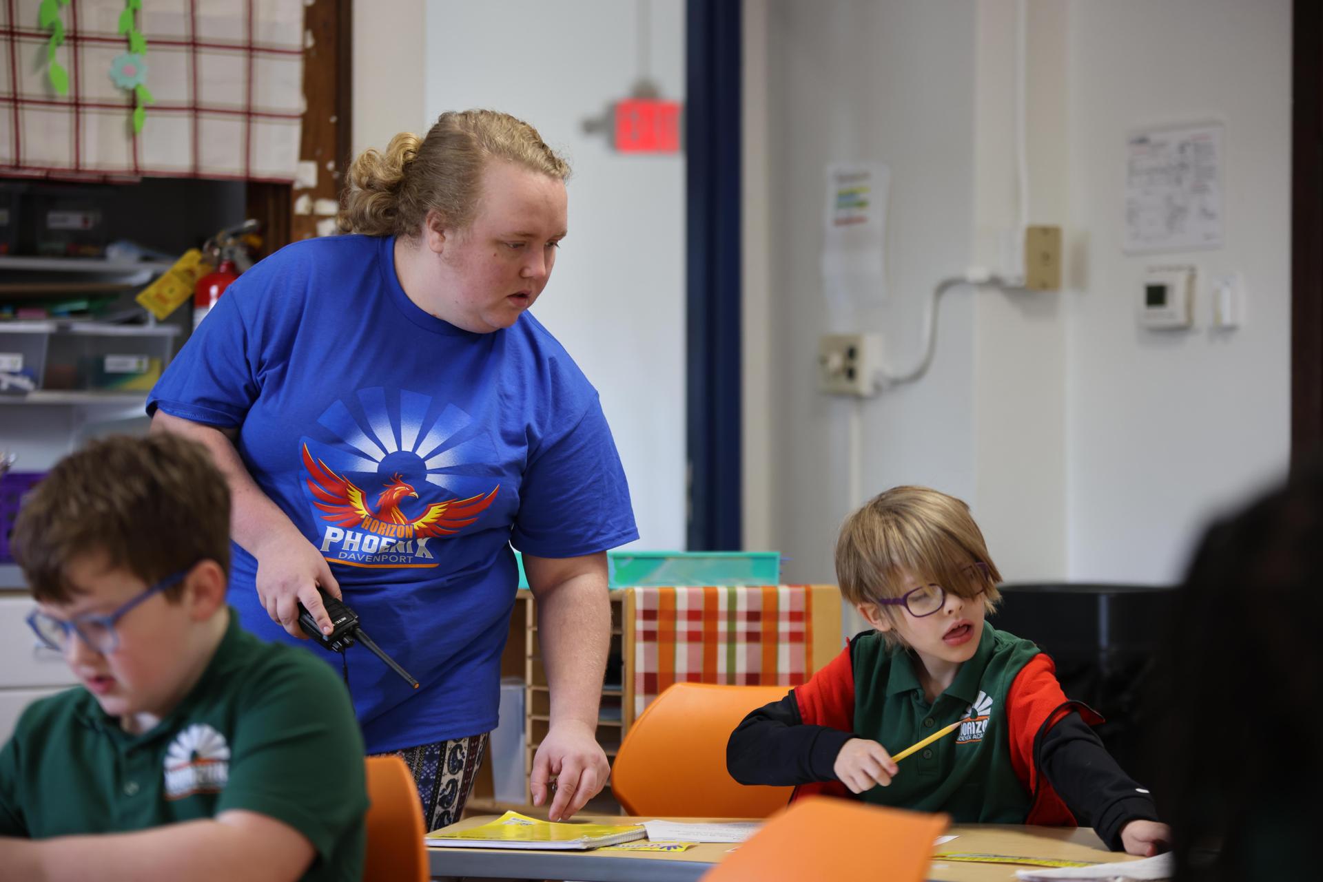 HSA Davenport Teacher and student interacting at a classroom desk