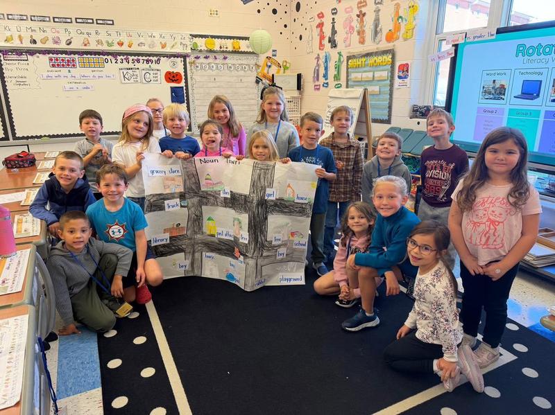 first graders holding their noun town they created