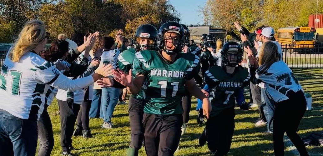 Wolfe football players welcomed by staff to the field