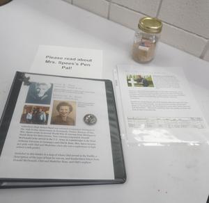 A jar of sand collected from Omaha Beach is displayed.