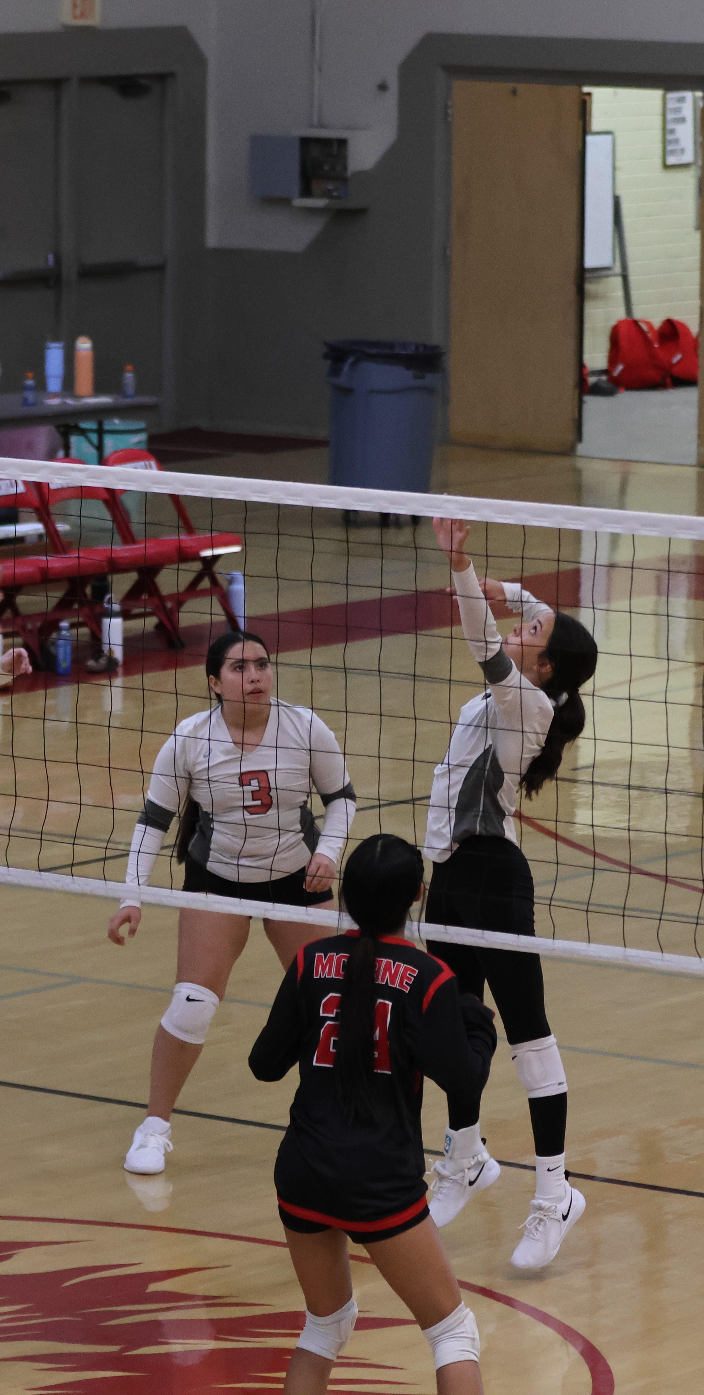 junior varsity girls playing volleyball 117