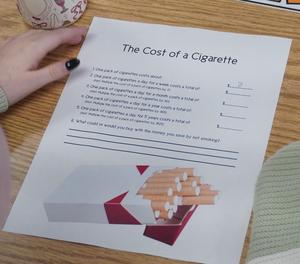 A student uses math to figure out the cost of cigarettes.