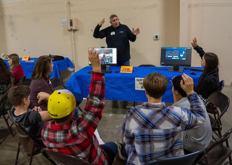 man talking with students