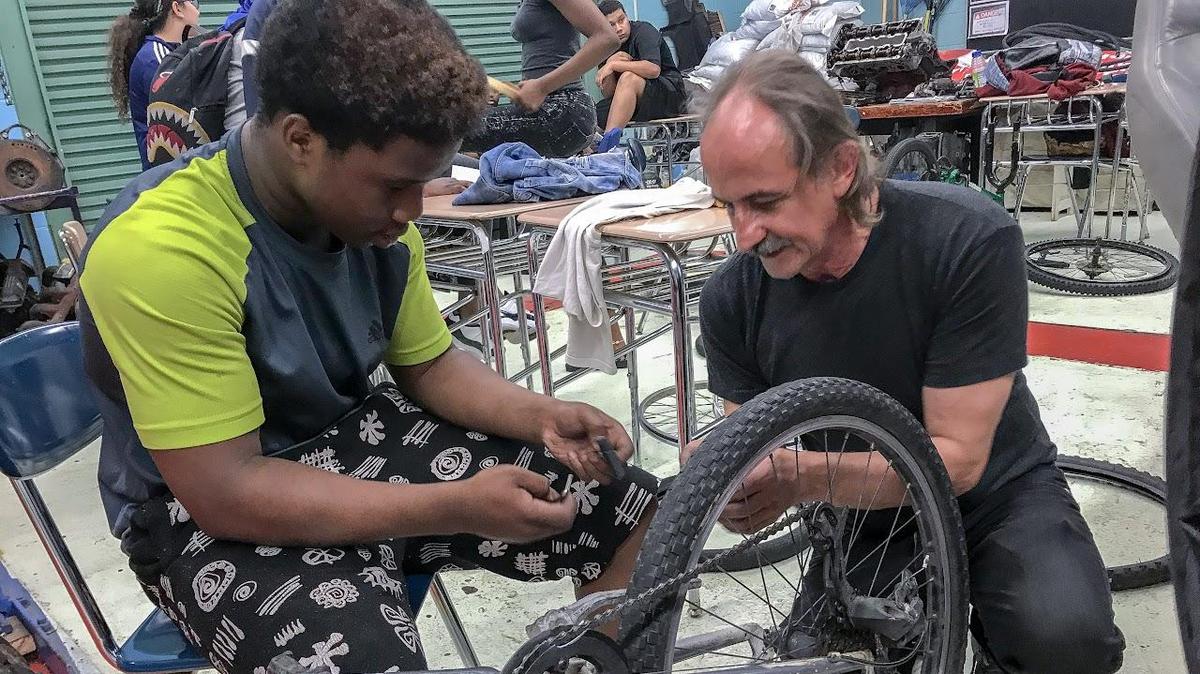 student working on bike