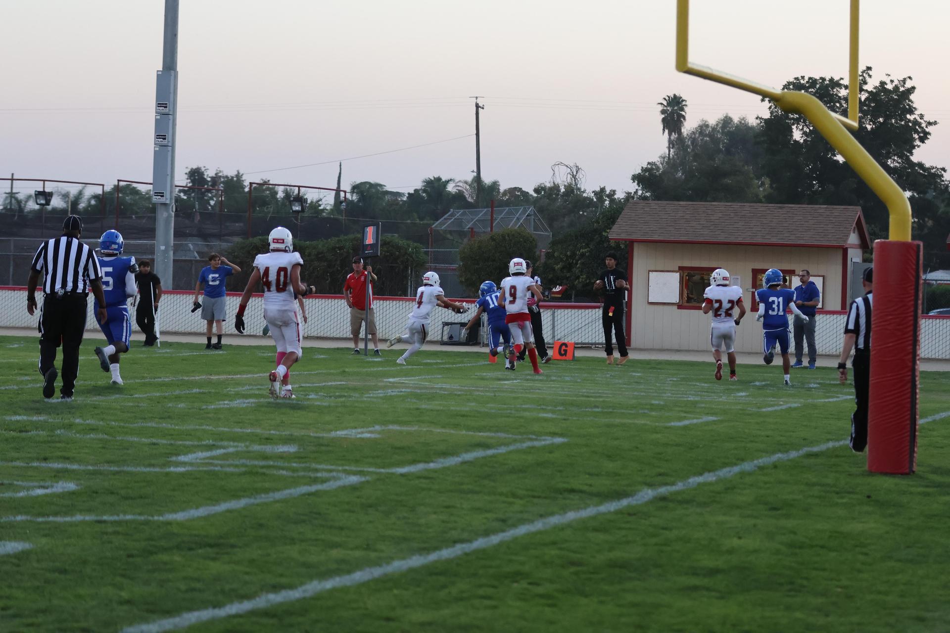 Junior Varsity football players in action against Caruthers