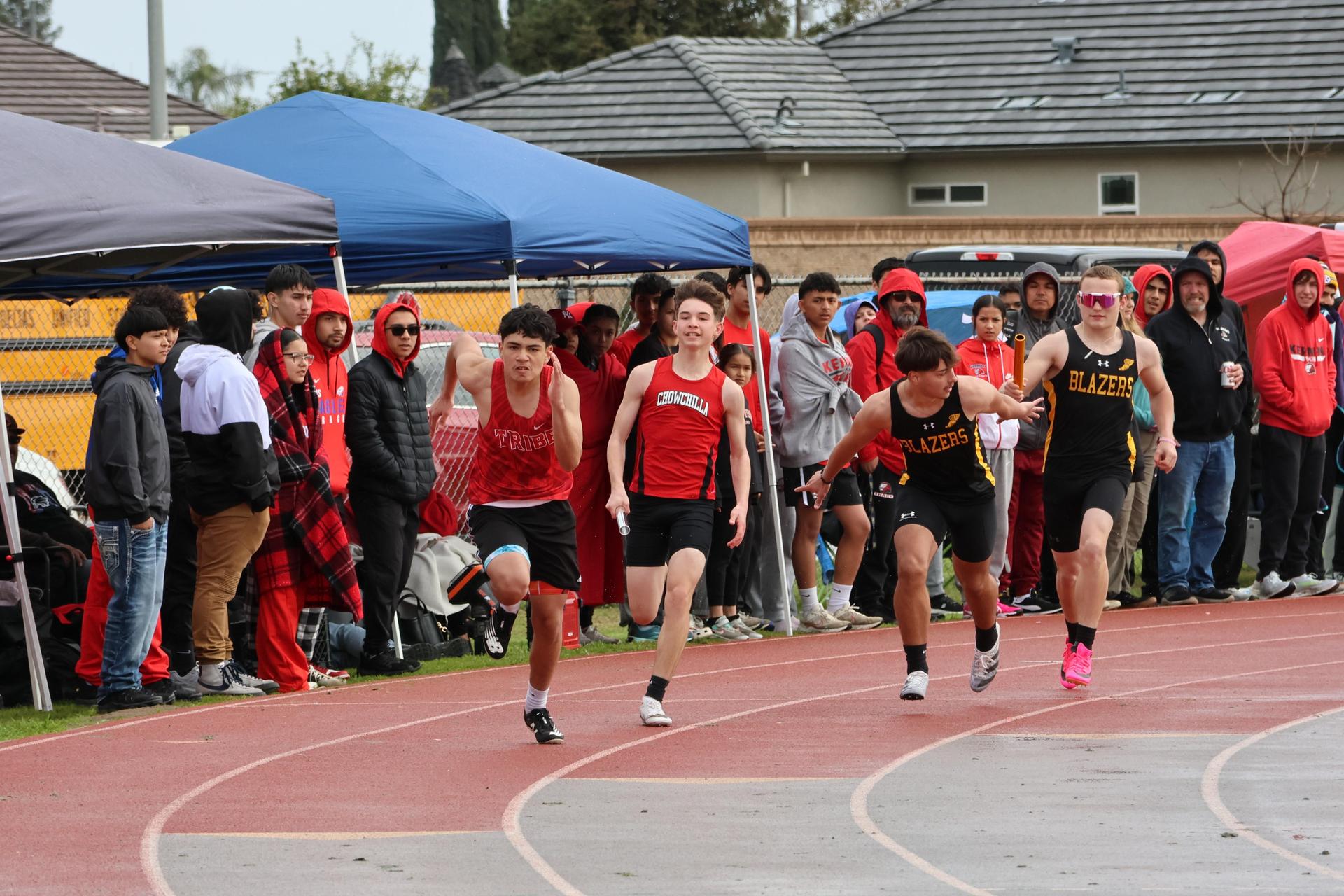 junior varsity boys running the four by 100 meter relay