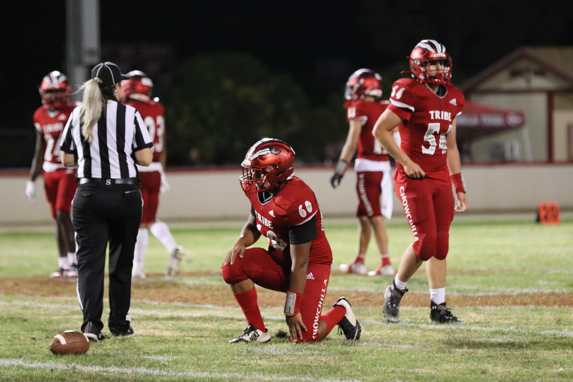 varsity football players in action against Riverdale