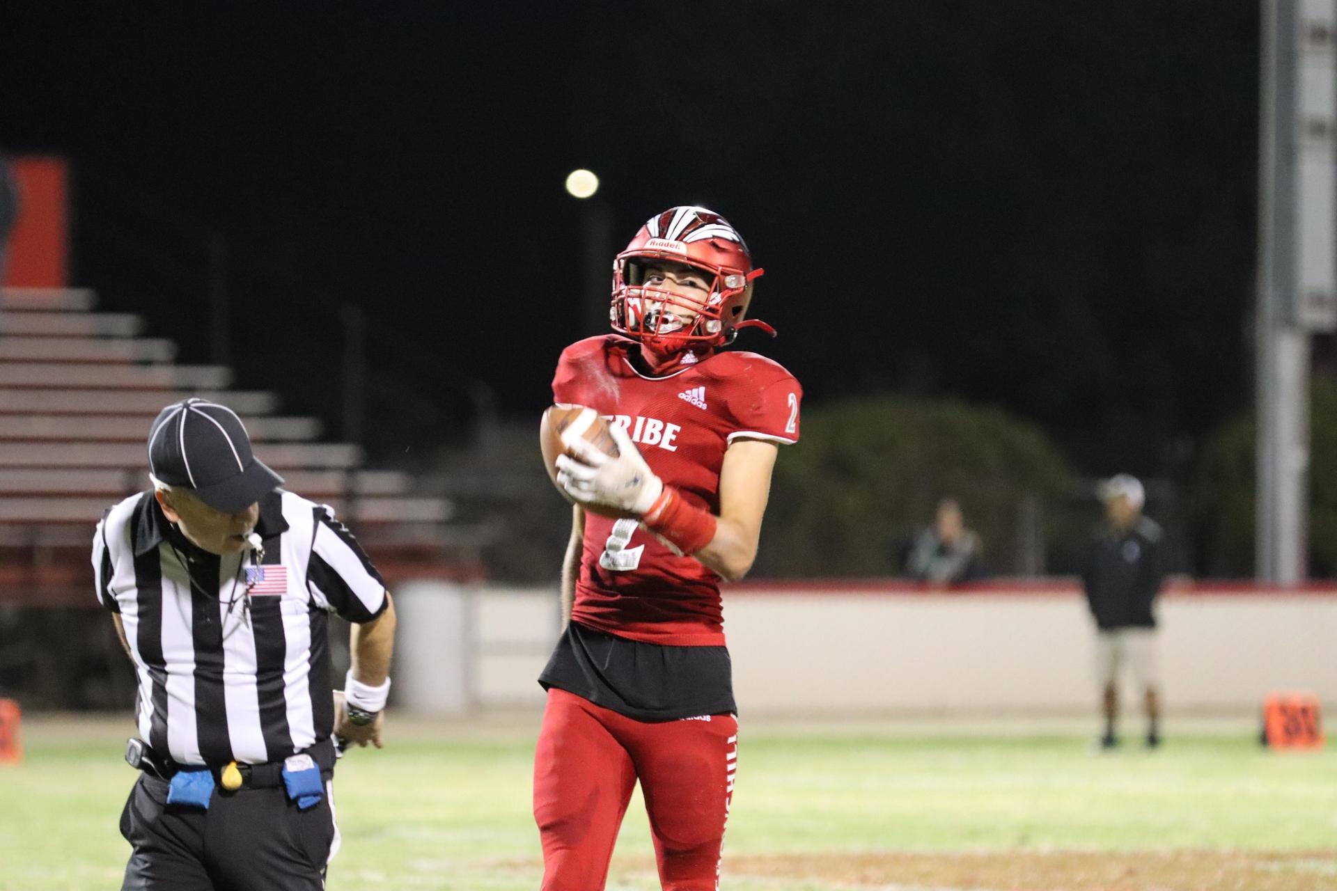 varsity football players in action against Riverdale