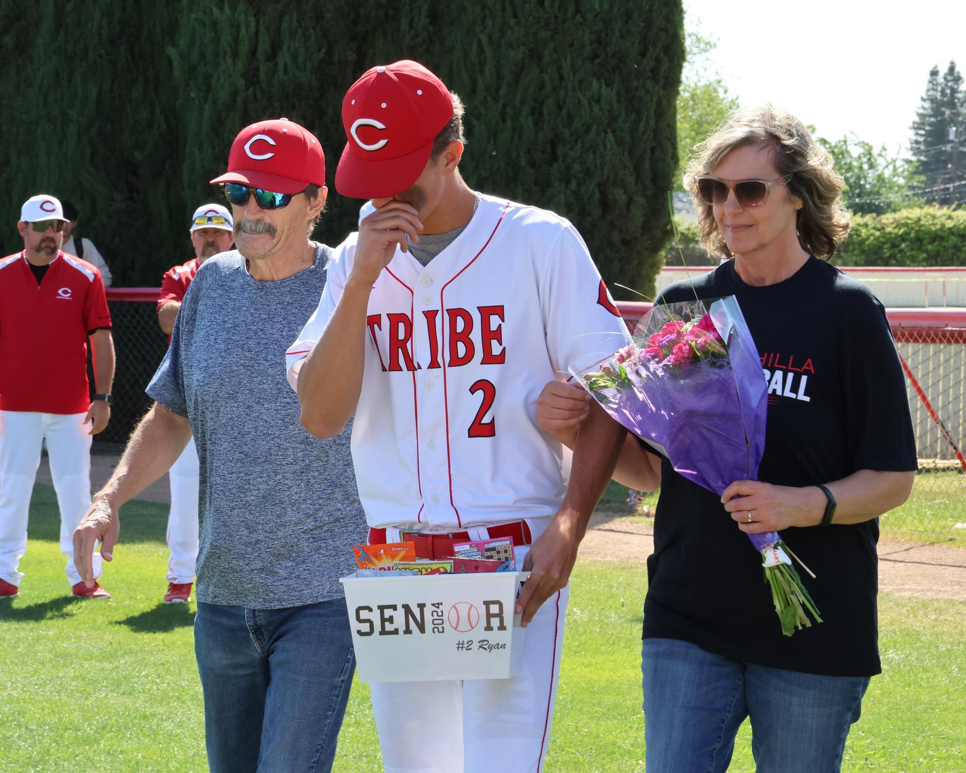Seniors Posing With Teammates, Coaches, And Family