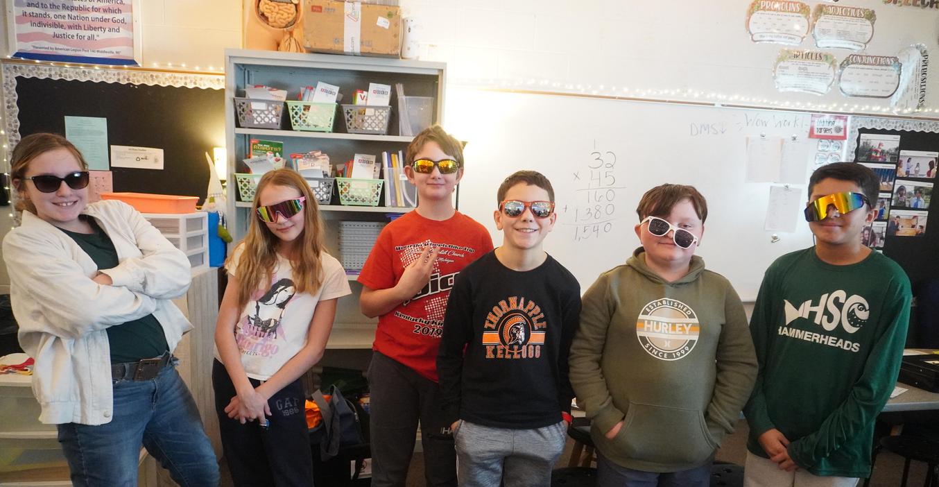 A group of students pose wearing the sunglasses during "Cool to be Kind" day.