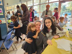 A student poses with her mother and sister.