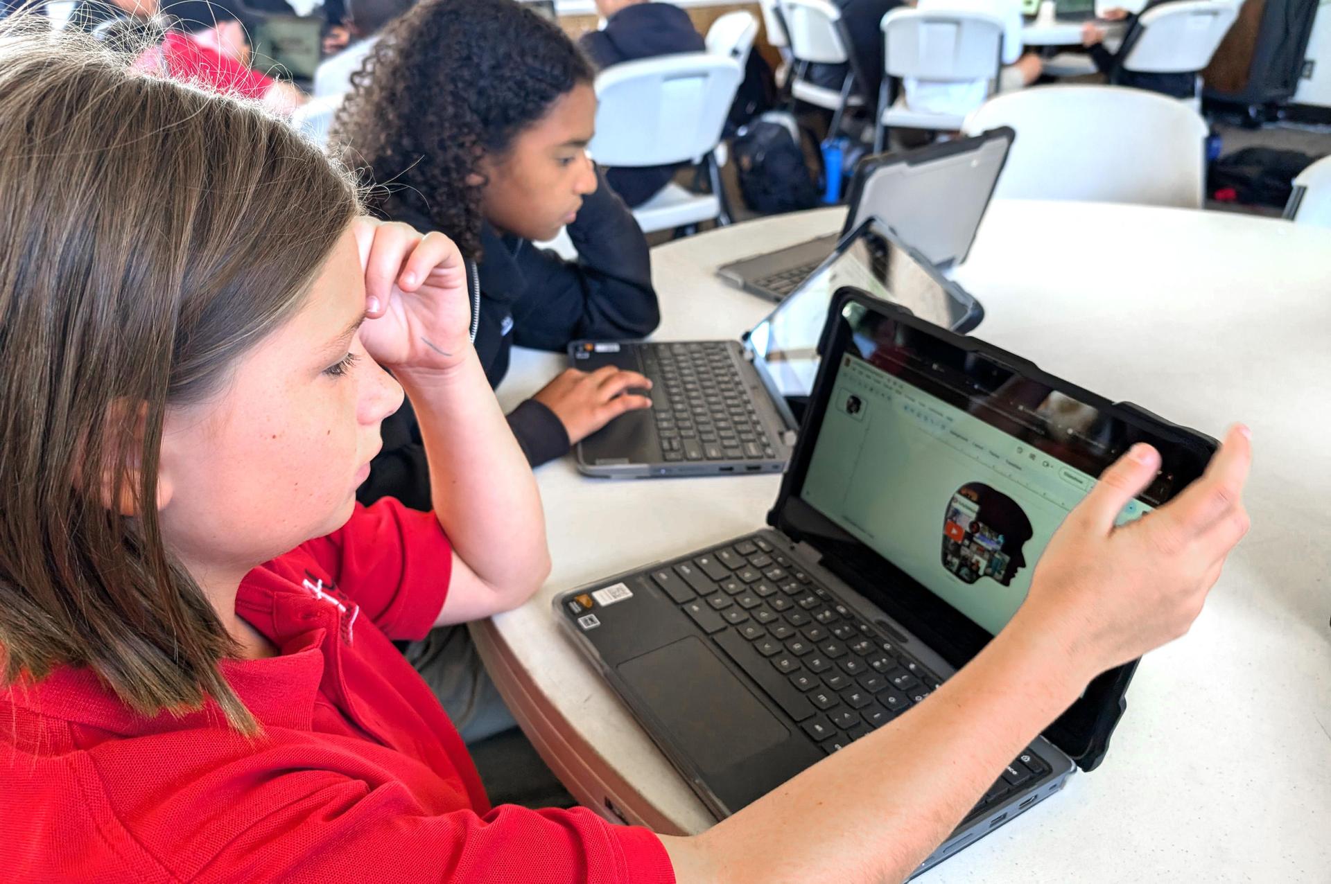 Middle school students using their Chromebooks.