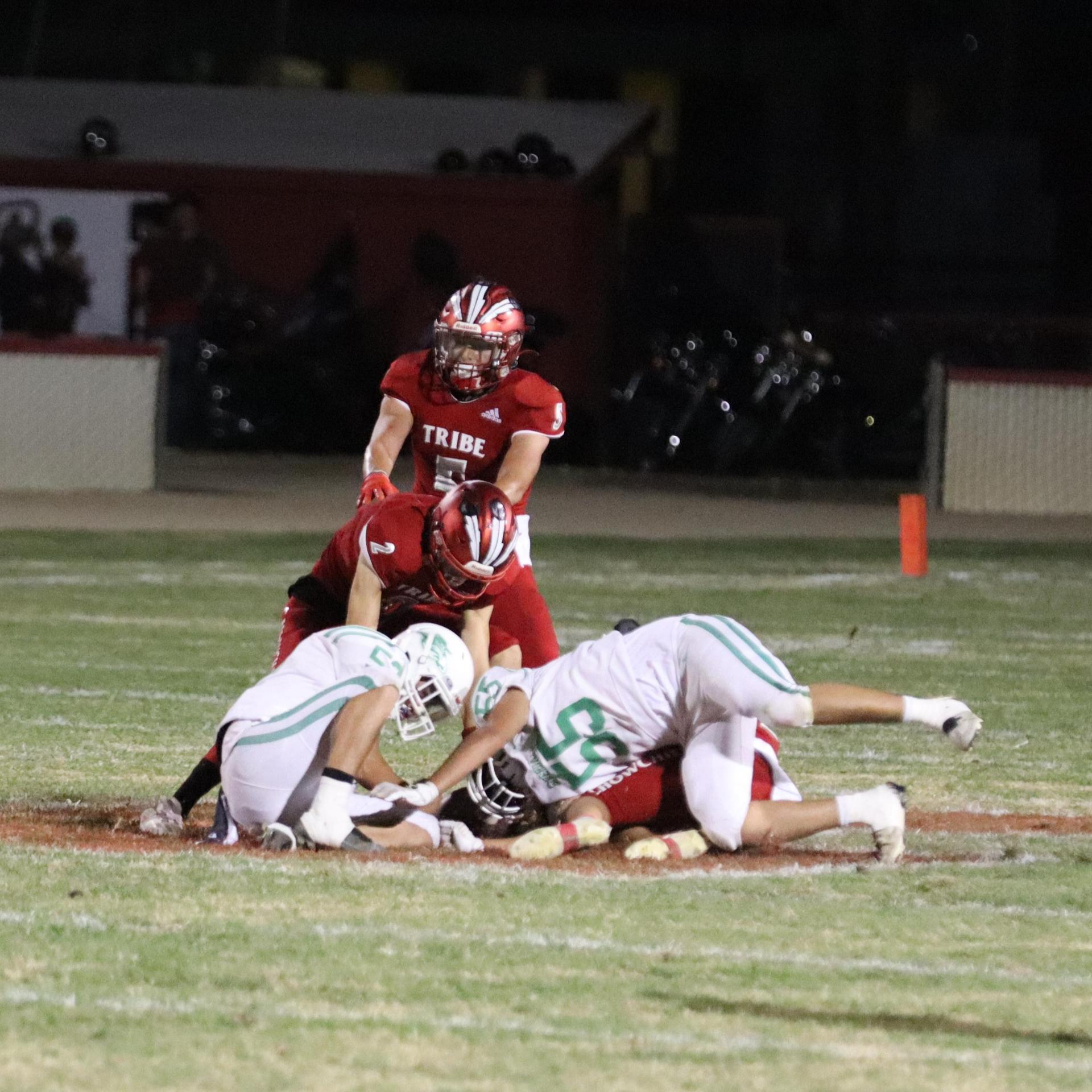 varsity football players in action against Riverdale