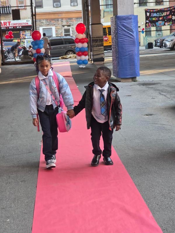 Students holding hand and returning on red carpet