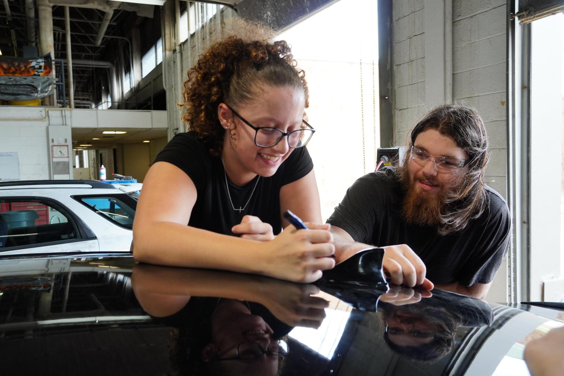 students fixing a car