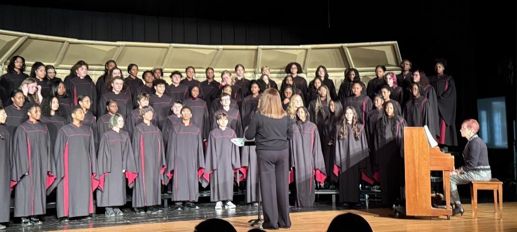 teacher conducts student choir