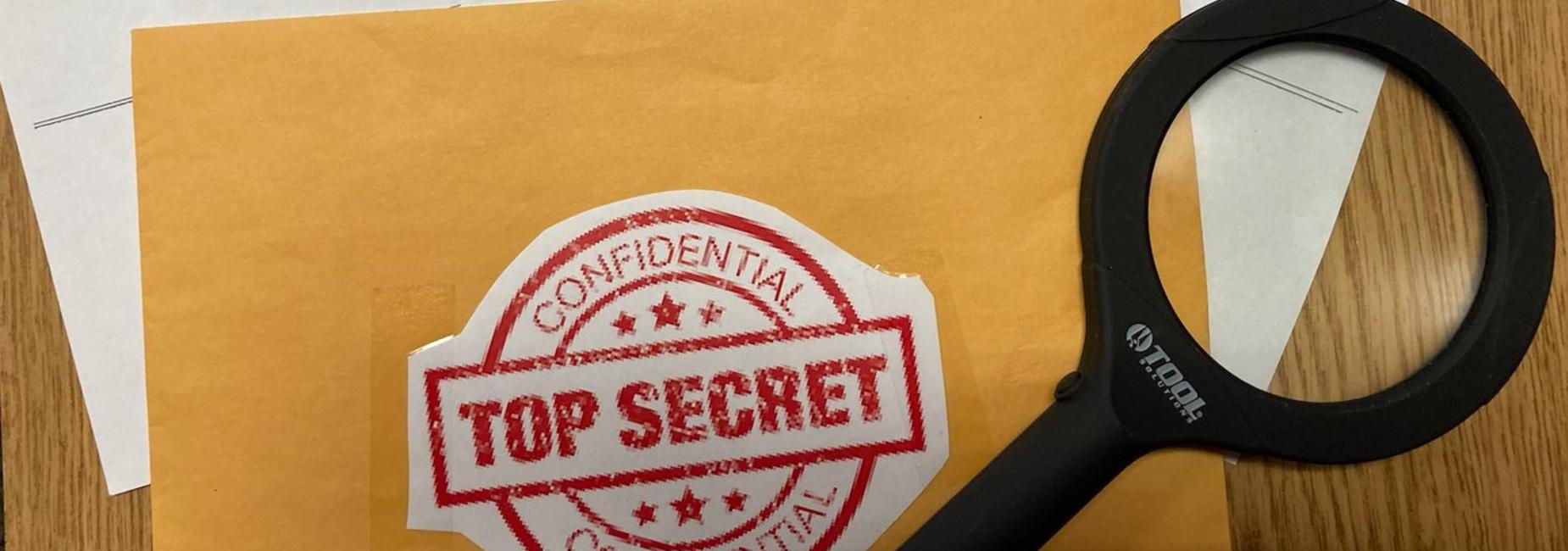 Envelope labeld Top Secret with Magnifying glass