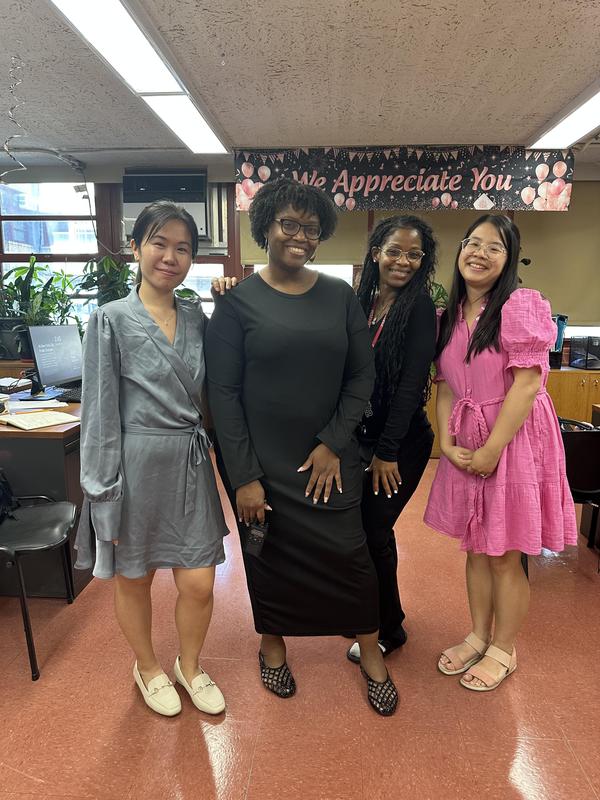 Staff members in all black, pink or blue