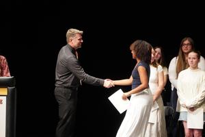 TKHS Assistant Principal congratulates a student.