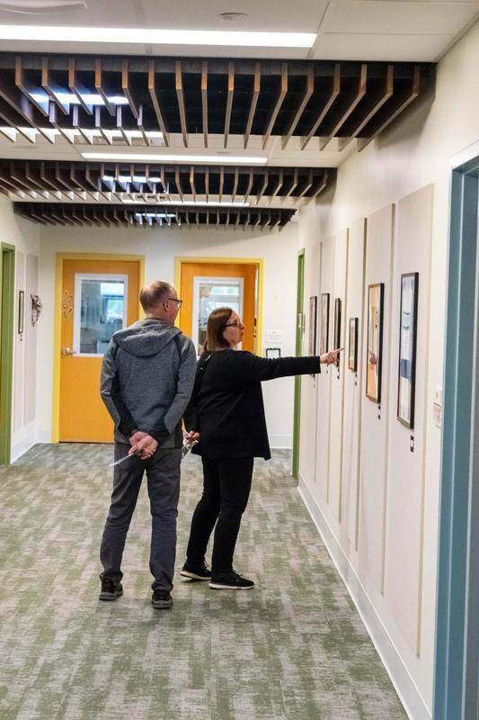 Two gallery goers enjoying artwork on the gallery walls